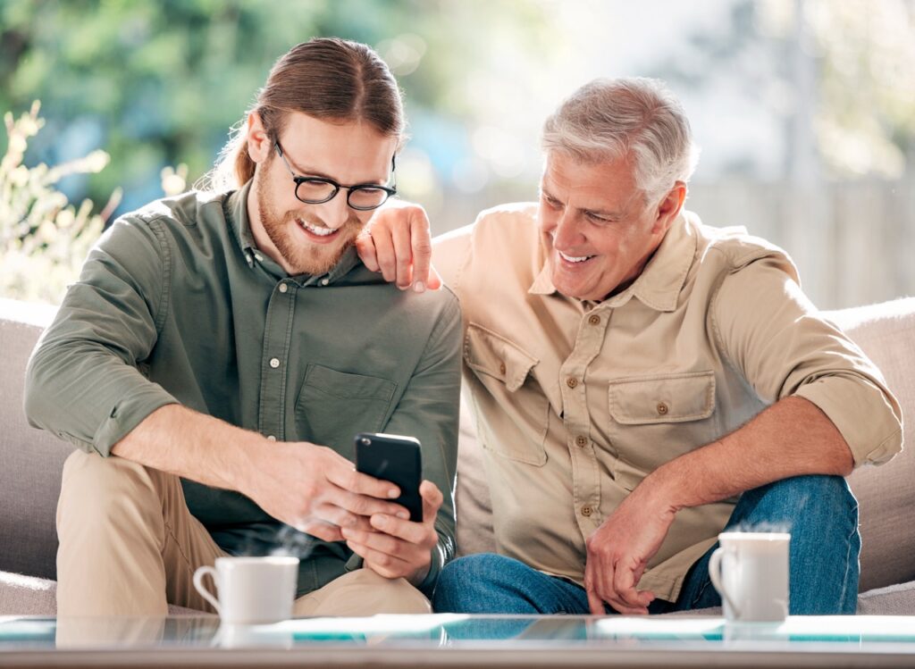 senior-man-son-with-phone-browsing-social-media-streaming-video-reading-online-news-smile-people-mobile-communication-article-multimedia-bonding-together-house
